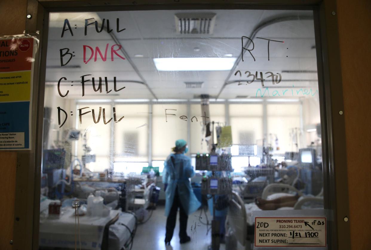 A clinician cares for COVID-19 patients in a makeshift ICU (Intensive Care Unit) at Harbor-UCLA Medical Center on Jan. 21, 2021, in Torrance, Calif.