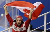 Ice Hockey – Pyeongchang 2018 Winter Olympics – Women Preliminary Round Match - U.S. v Canada - Kwandong Hockey Centre, Gangneung, South Korea – February 15, 2018 - A Canadian fan waves the Canadian national flag during a game with Team USA. REUTERS/David W Cerny