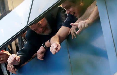 Former Brazilian President Luiz Inacio Lula da Silva waves to supporters from a window during a protest at the metallurgic trade union in Sao Bernardo do Campo, Brazil April 6, 2018. REUTERS/Leonardo Benassatto