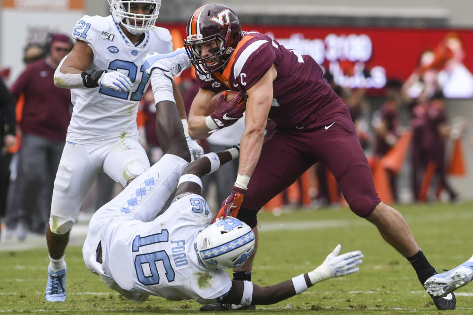 BLACKSBURG, VA - OCTOBER 19: Tight end Dalton Keene #29 of the Virginia Tech Hokies stiff arms defensive back D.J. Ford #16 of the North Carolina Tar Heels in the first half at Lane Stadium on October 19, 2019 in Blacksburg, Virginia. (Photo by Michael Shroyer/Getty Images)