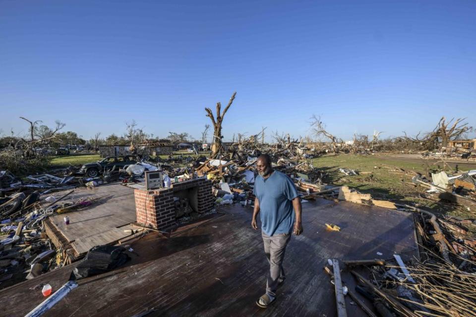 A resident surveys the damage after a tornado ripped through Mississippi on Saturday.