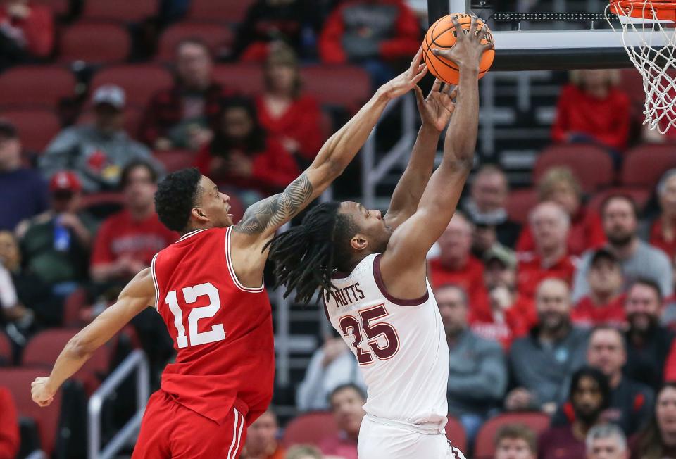 Louisville forward JJ Traynor blocks the potential slam from Virginia Tech forward Justyn Mutts in the Cards' final home game of the regular season Tuesday night at the KFC Yum Center. Feb. 28, 2023