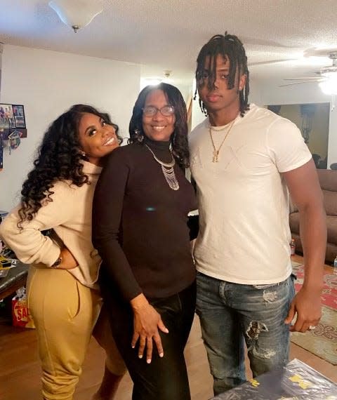 Michigan defensive end Jaylen Harrell, right, with his sister, Dominique, left, and mother, Aria Siplin.