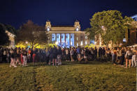 Students gathering on the Syracuse University campus on Wednesday Aug. 19, 2020, in Syracuse, NY. Syracuse University has issued suspensions to 23 students in the wake of the large on-campus gathering that administrators say could force them to shut down campus. College officials announced the disciplinary action late Thursday, Aug. 21, 2020. (Walter Freeman via AP)