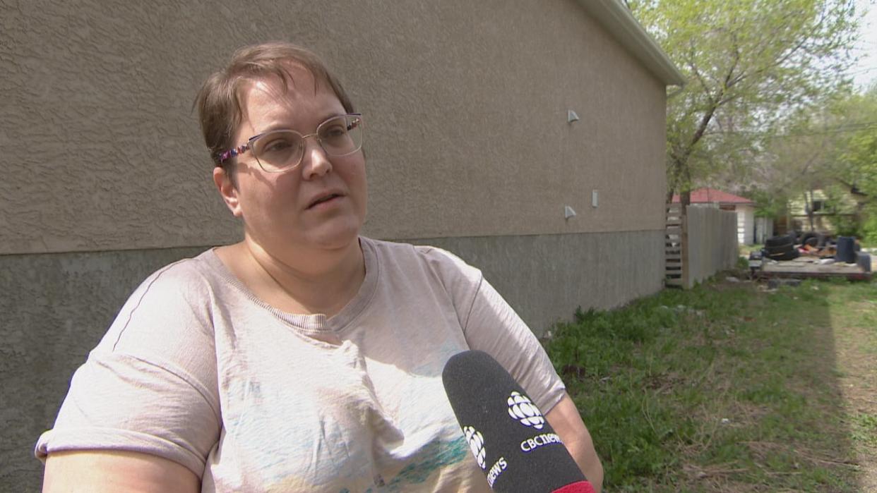 Dawn Thomas-Cameron recently got a notice from the City of Regina, ordering her to remove garbage on her property. That includes a flatbed trailer she says someone else dumped there. (Adam Bent/CBC - image credit)