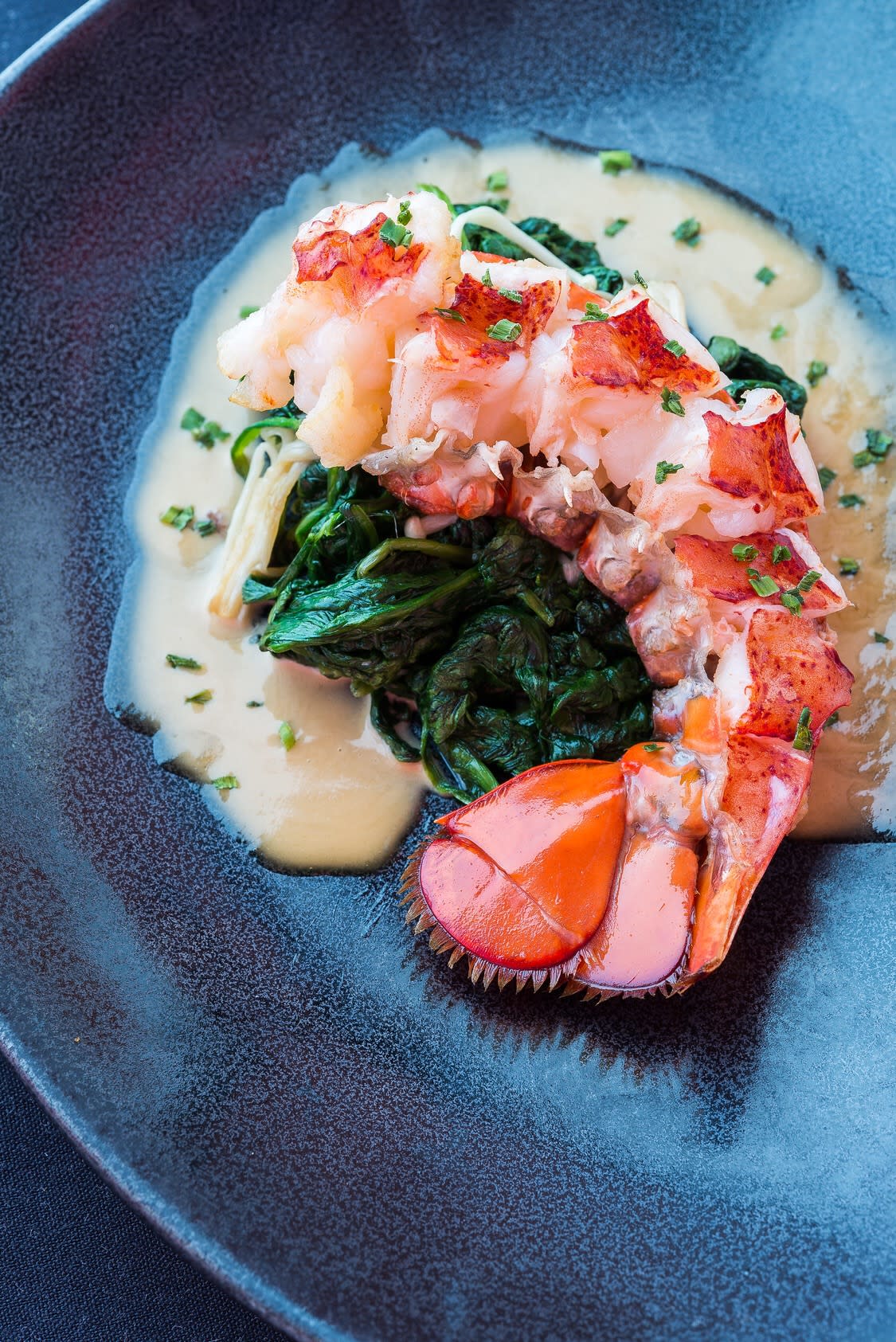 This lobster tail dish is served with uni butter sauce and sautéed spinach. (Photo: Daisuke Utagawa/Sushiko)