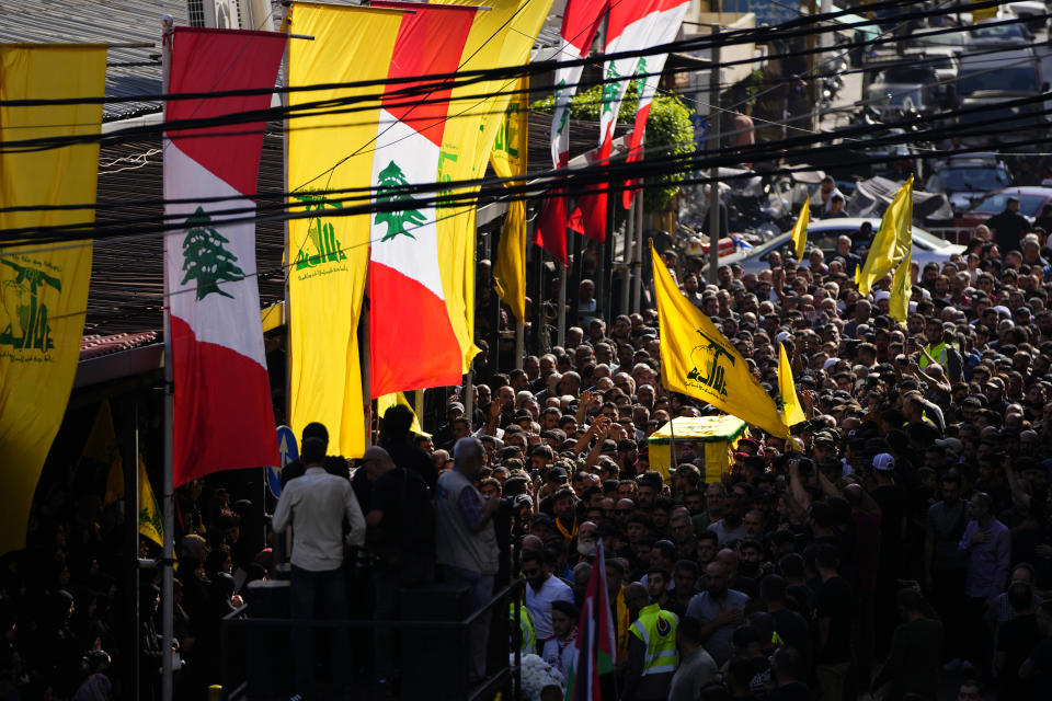 Hezbollah fighters carry the coffin of their comrade, Qassim Ibrahim Abu-Taam, who was killed along Lebanon's southern border with Israel, during his funeral procession in the southern Beirut suburb of Dahiyeh, Lebanon, Monday, Nov. 6, 2023. (AP Photo/Hassan Ammar)
