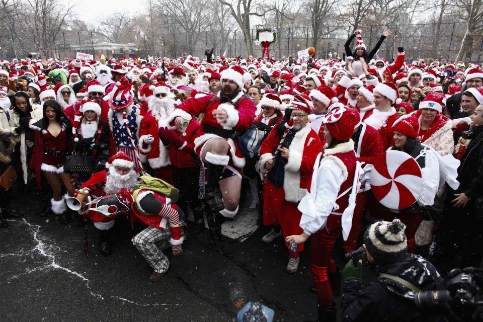 Revellers dressed as Santa Claus pose during SantaCon in New York