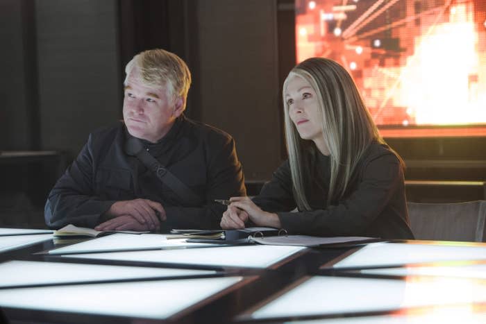 Julianne and Seymour in the film sitting at a large table