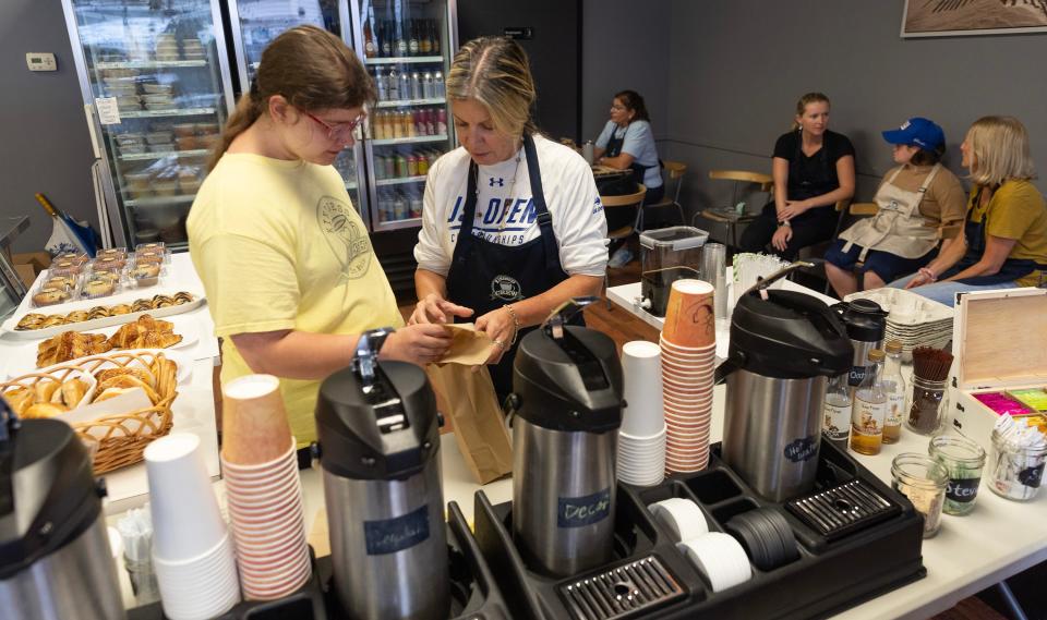 Volunteer Theresa Polkowski of Brick helps Kyla Harper of Wall put together customer orders. Kindness Café in Manasquan, which operates out of Main Street Kitchen three mornings per week, employs a staff of young adults with developmental disabilities.