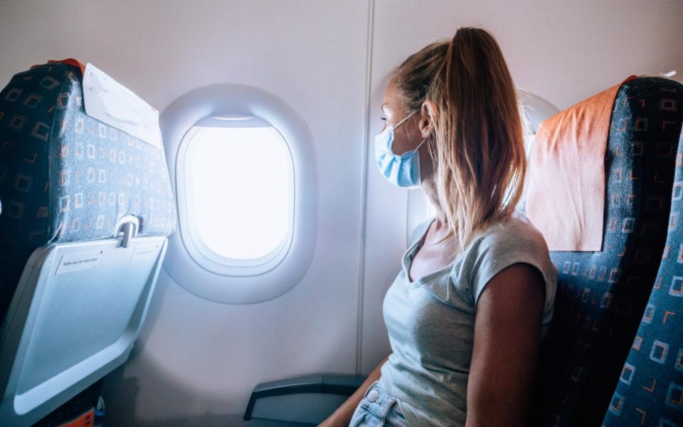 woman on plane in mask