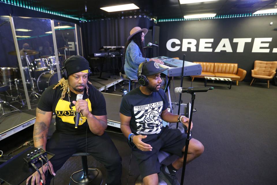 From left, Eddie “Million” Miller and Brian Frazier sit where people perform and record music while Micki Miller, back, singer/songwriter/producer, stands at the keyboards Monday, Sept. 26, 2023, in the South Bend studio.