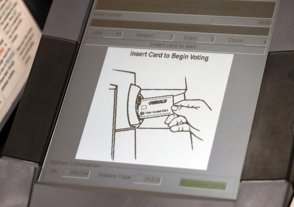 FILE - This May 9, 2018, photo shows a touch screen of a voting machine during early voting in Sandy Springs, Ga. New voting machines that combine touchscreens with paper ballots are getting a limited test run in Georgia. It's part of an effort to meet a court-ordered deadline to retire the old touchscreen only system before any votes are cast in 2020. (AP Photo/John Bazemore, File)