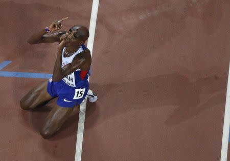 Mo Farah of Britain gestures after winning the men's 5000 metres final at the 15th IAAF Championships at the National Stadium in Beijing, China August 29, 2015. REUTERS/Fabrizio Bensch