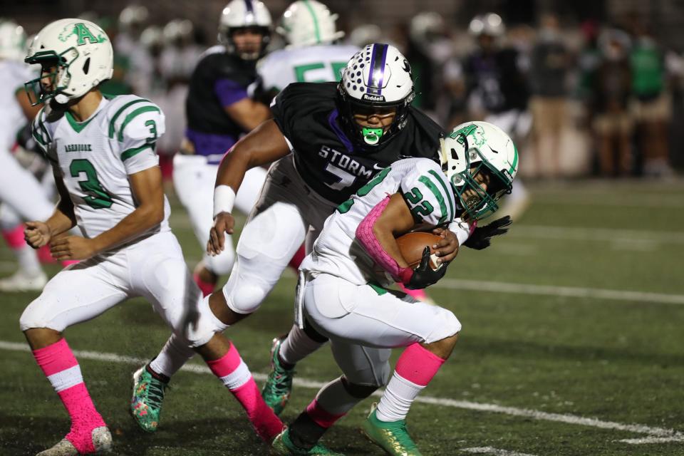 Stuart Cramer's Arias Nash brings down an Ashbrook ball carrier Thursday night in Belmont. The Storm defeated the Greenwave 31-20. (Brian Mayhew for the Gaston Gazette)