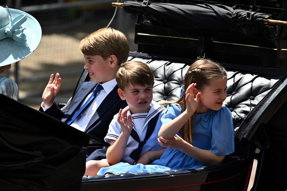 Britain's Prince George of Cambridge, Britain's Prince Louis of Cambridge and Britain's Princess Charlotte of Cambridge travel in a horse-drawn carriage back to Buckingham Palace during the Queen's Birthday Parade, the Trooping the Colour, as part of Queen Elizabeth II's platinum jubilee celebrations, in London on June 2, 2022. - Huge crowds converged on central London in bright sunshine on Thursday for the start of four days of public events to mark Queen Elizabeth II's historic Platinum Jubilee, in what could be the last major public event of her long reign. (Photo by Ben Stansall / AFP) (Photo by BEN STANSALL/AFP via Getty Images)