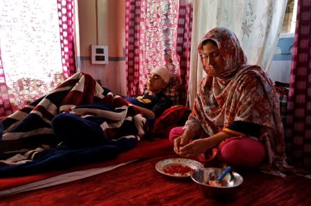 The Wider Image: Barricades and books in restive Kashmir neighbourhood