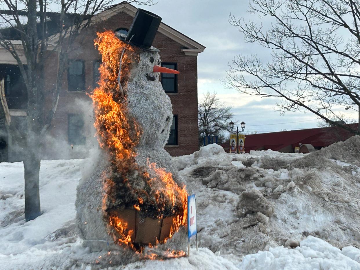 The burning snowman, made of a wire frame and paper products, burns away to symbolize the beginning of spring on March 20, 2023 at Lake Superior State University in Sault Ste. Marie.