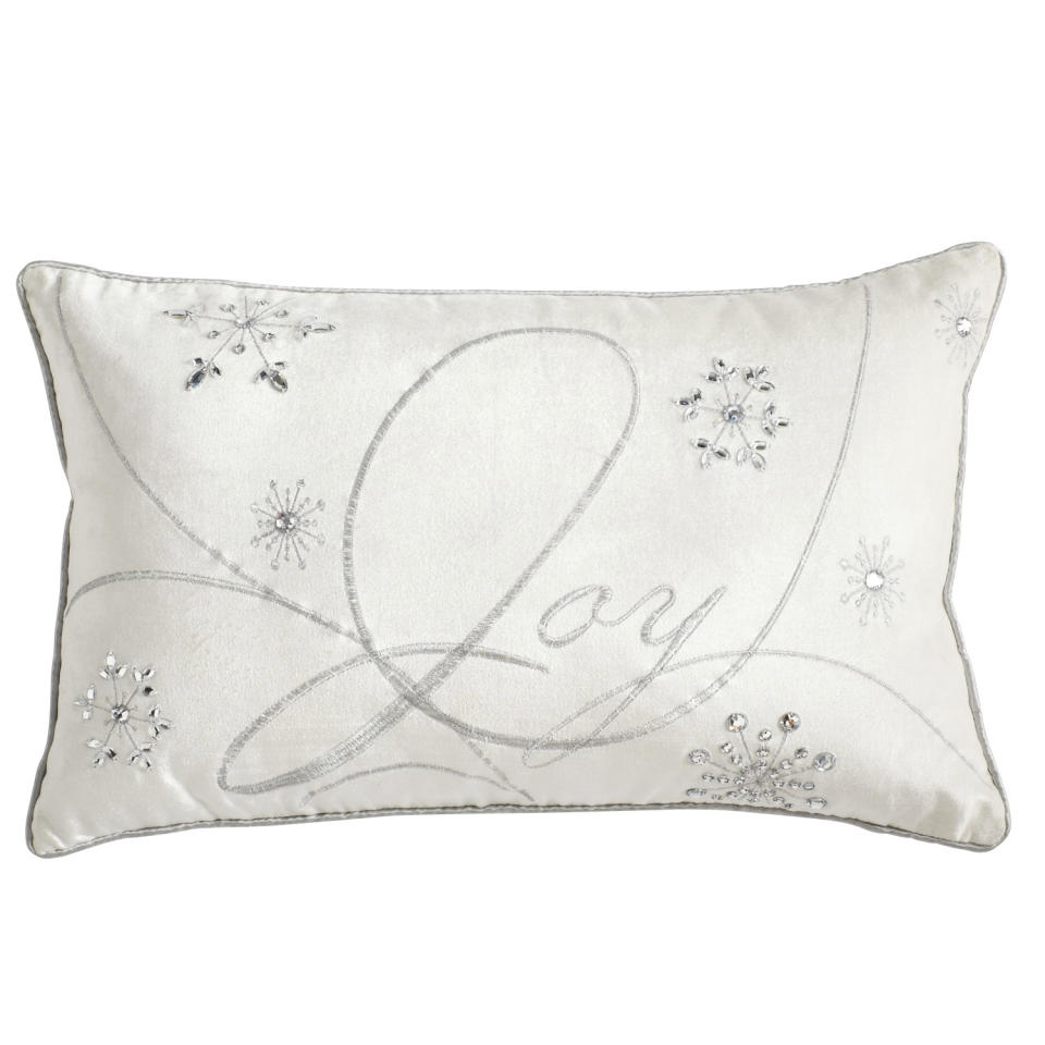 In this photo provided by Pier 1 Imports, soft ivory velvet is inscribed with silvery lettering on this elegant decorative Joy pillow from Pier1.com. Accent pieces like throw pillows are another way to introduce seasonal decor beyond the ornaments. Following the general trend in home decor, holiday trim and accessories this year are a mix of eclectic and traditional colors and styles. (AP Photo/Pier 1 Imports)