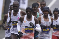Eliud Kipchoge, of Kenya, center, runs ahead of Andualem Belay, of Ethiopia, second from right, at the front of a group of elite men, along the course of the 127th Boston Marathon, Monday, April 17, 2023, in Framingham, Mass. (AP Photo/Steven Senne)