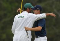 Jordan Spieth of the U.S. celebrates with his caddie Michael Greller on the 18th green after winning the Masters golf tournament at the Augusta National Golf Course in Augusta, Georgia April 12, 2015. REUTERS/Brian Snyder