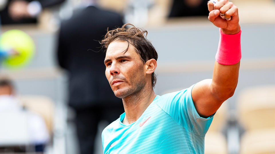 Rafael Nadal fist-pumps after victory over Mackenzie McDonald at the French Open.