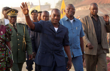 FILE PHOTO: Joseph Kabila, the president of the transitional government and a presidential candidate for upcoming elections in the Democratic Republic of Congo, waves to supporters in Bunia, the regional capital of Ituri region, July 12, 2006. REUTERS/Stringer/File Photo
