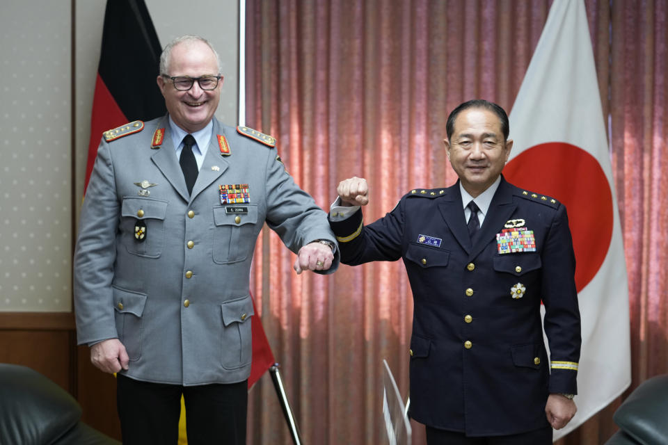 Gen. Eberhard Zorn, chief of Defense of the German Armed Forces, left, and Gen. Koji Yamazaki, chief of Staff, Joint Staff of the Japan Self-Defense Forces, pose for a photo before their talk at the Ministry of Defense in Tokyo, Friday, Nov. 5, 2021. (AP Photo/Hiro Komae)