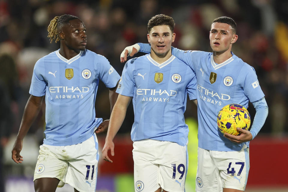 Manchester City's Phil Foden, right, celebrates with Manchester City's Julian Alvarez, center, and Manchester City's Jeremy Doku at the end of the English Premier League soccer match between Brentford and Manchester City at the Gtech Community Stadium in London, Monday, Feb. 5, 2024. (AP Photo/Ian Walton)