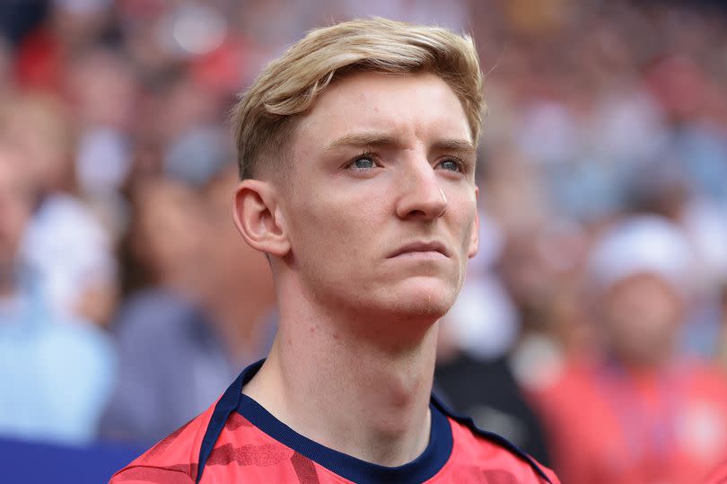 Anthony Gordon of England looks on during the line up for the national anthems prior to kick off in the UEFA EURO 2024 quarter-final match between England and Switzerland