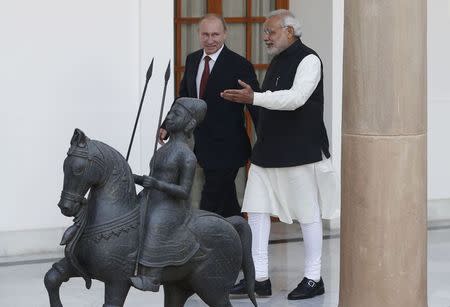 Russian President Vladimir Putin (L) and India's Prime Minister Narendra Modi arrives for a photo opportunity ahead of their meeting at Hyderabad House in New Delhi December 11, 2014. REUTERS/Adnan Abidi