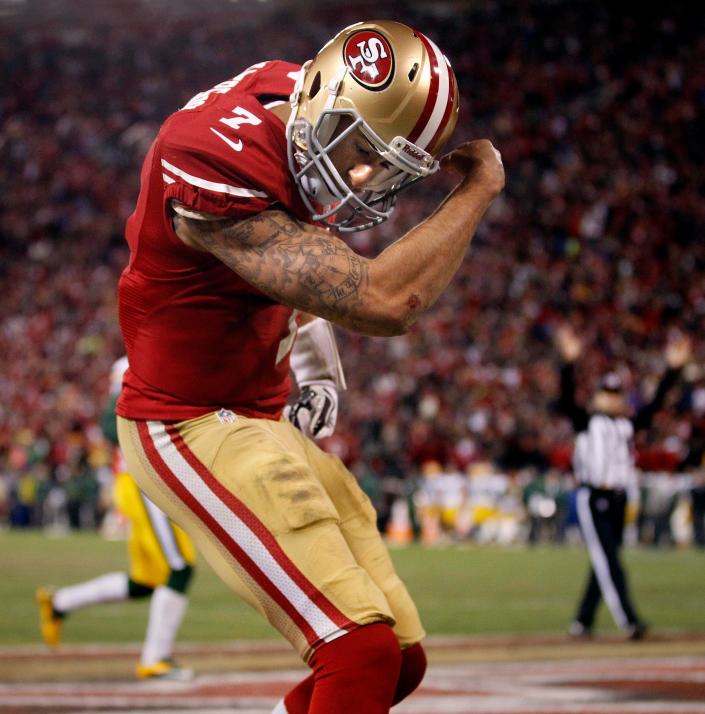 San Francisco 49ers quarterback Colin Kaepernick (7) flexes his muscles after scoring a touchdown during their 45-31 victory over Green Bay Packers in their NFC Divisional playoff game Saturday, January 11, 2013 at Candlestick Park in San Francisco, Calif.