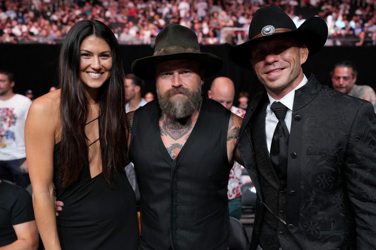 Zac Brown (center) and Kelly Yazdi (left), seen here in June 2022, shared in a statement on Dec. 29 that they are seeking a divorce.