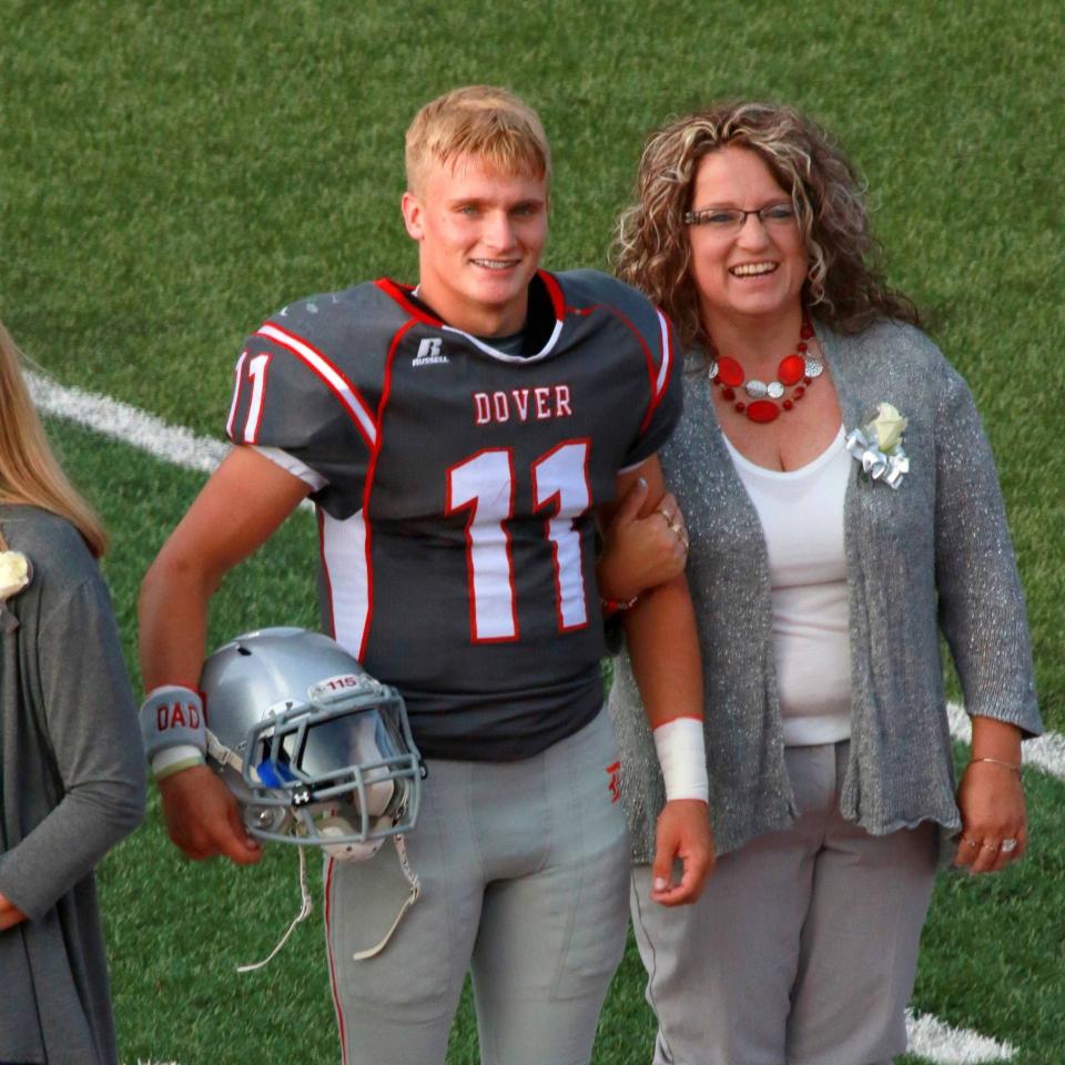 Dre Hess, a 2018 Dover High School graduate, is shown with his mother Liz Miller at the Crimson Tornadoes' senior night.