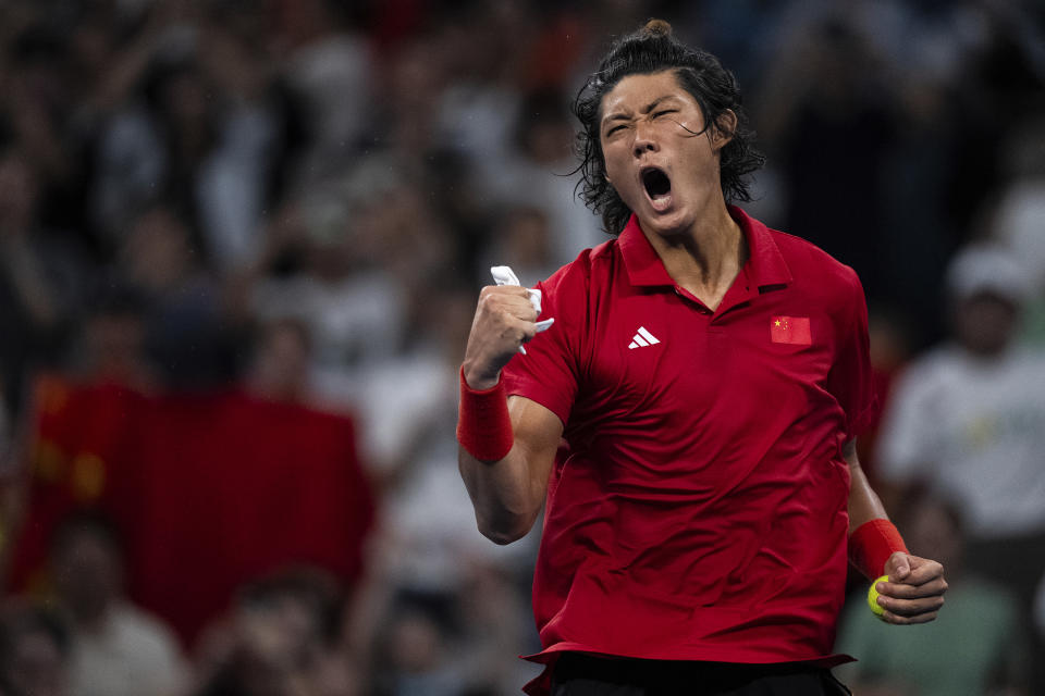 China's Zhang Zhizhen celebrates after victory at the tennis men's singles final at the 19th Asian Games in Hangzhou, China, Saturday, Sept. 30, 2023. (AP Photo/Louise Delmotte)