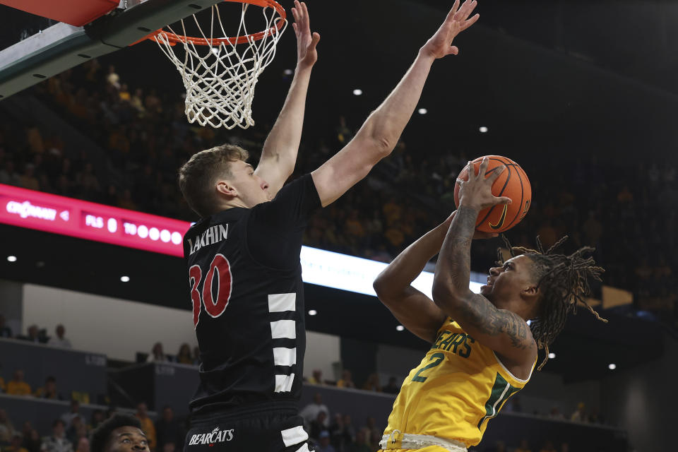 Baylor guard Jayden Nunn (2) is fouled by Cincinnati forward Viktor Lakhin (30) during the first half of an NCAA college basketball game Saturday, Jan. 13, 2024, in Waco, Texas. (AP Photo/Jerry Larson)