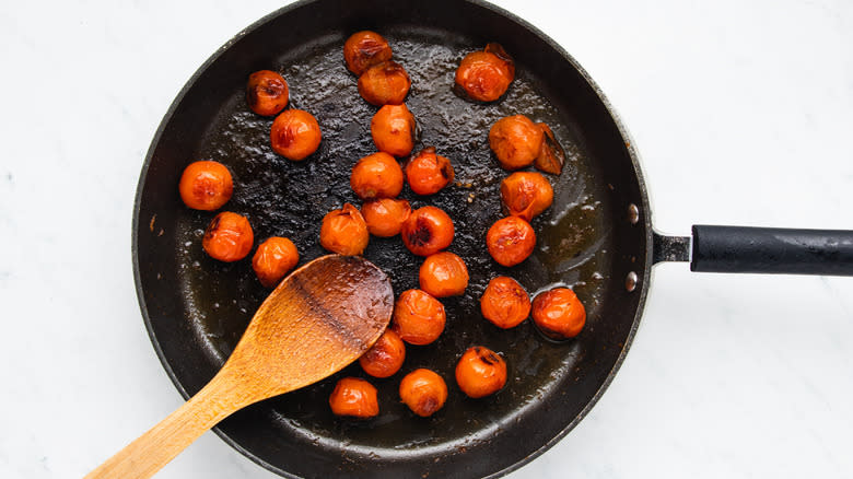 Cherry tomatoes frying in pan