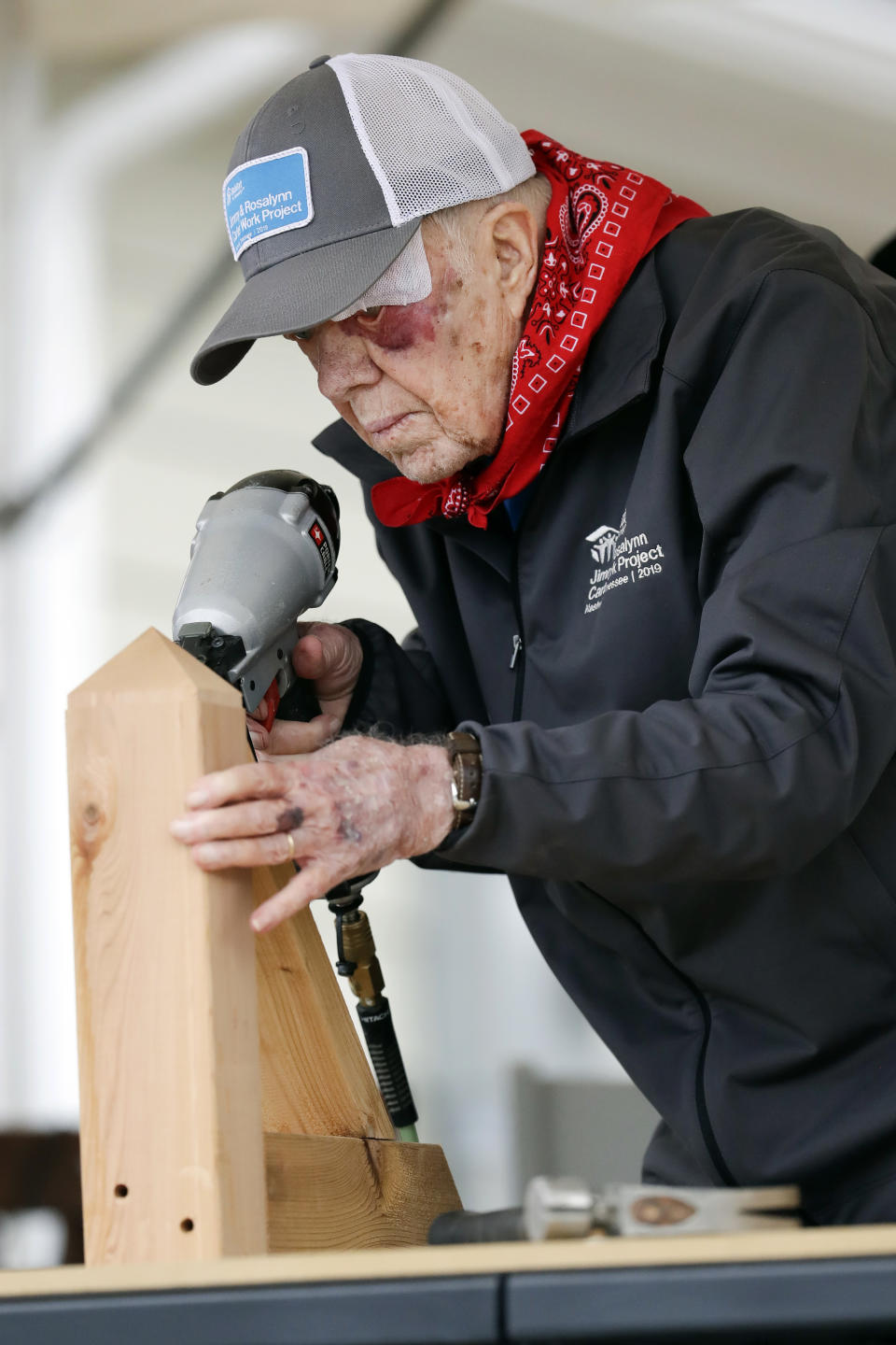 With a bandage above his left eye and a large, red welt below it, former President Jimmy Carter builds corbels at a Habitat for Humanity project Monday, Oct. 7, 2019, in Nashville, Tenn. Carter fell at home on Sunday, requiring 14 stiches, but he did not let his injuries keep him from participating in his 36th building project with the nonprofit Christian housing organization. He turned 95 last Tuesday, becoming the first U.S. president to reach that milestone. (AP Photo/Mark Humphrey)