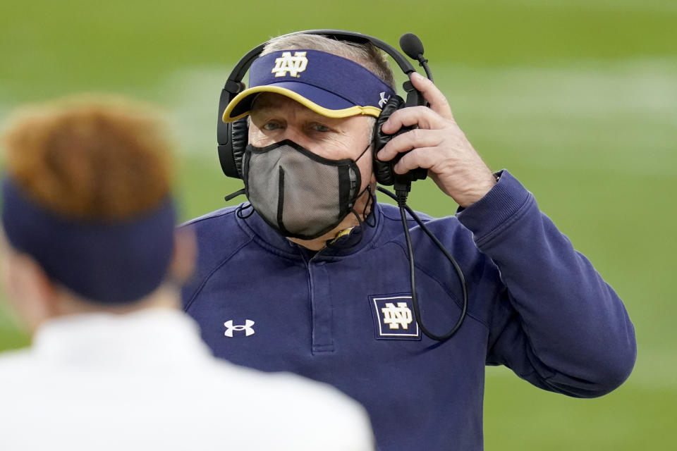 Notre Dame head coach Brian Kelly adjusts his headset as he walks to talk to Jonathan Doerer during the second half of an NCAA college football game against Pittsburgh, Saturday, Oct. 24, 2020, in Pittsburgh. (AP Photo/Keith Srakocic)