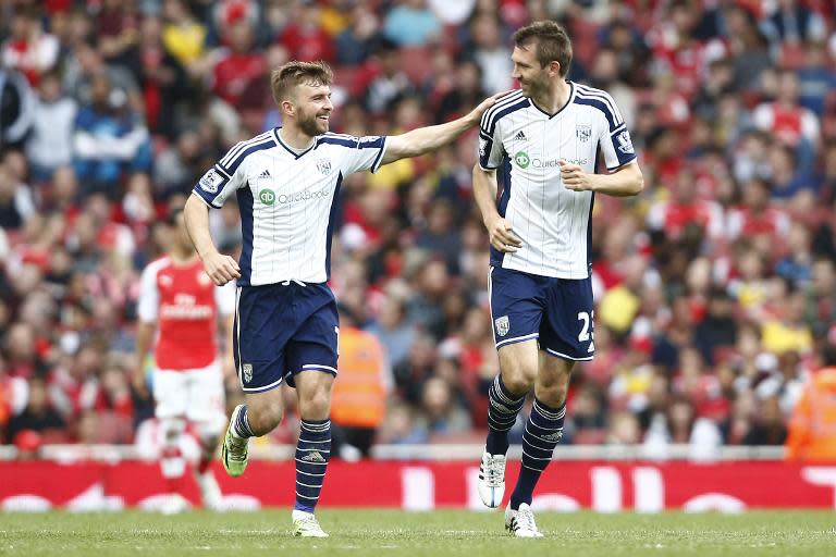 West Bromwich Albion's Gareth McAuley (R) celebrates after scoring during the Premier League match against Arsenal at Emirates Stadium on May 24, 2015