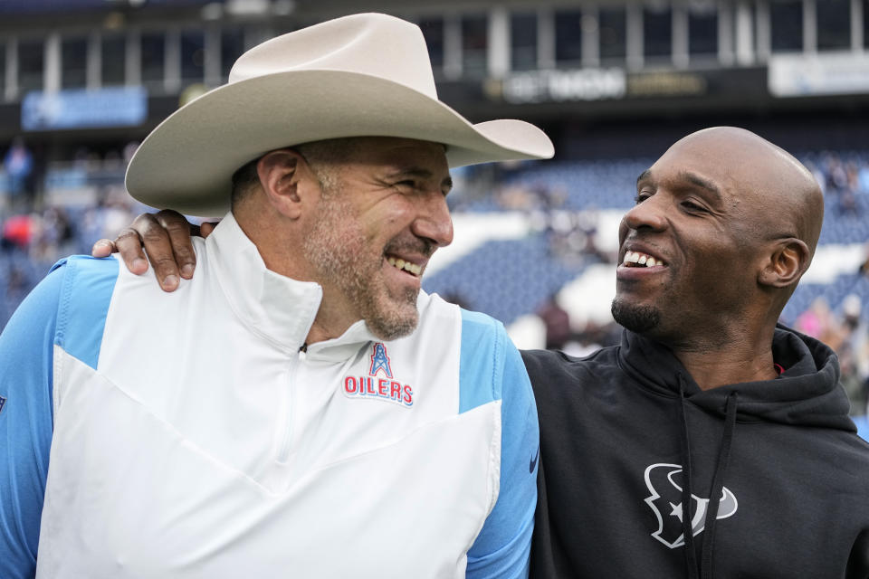 Tennessee Titans head coach Mike Vrabel, left, and Houston Texans head coach DeMeco Ryans speak before an NFL football game between the two teams, Sunday, Dec. 17, 2023, in Nashville, Tenn. (AP Photo/George Walker IV)