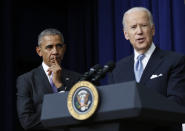 FILE - In this Dec. 13, 2016, file photo, President Barack Obama listens as Vice President Joe Biden speaks in the South Court Auditorium in the Eisenhower Executive Office Building on the White House complex in Washington. Biden is getting some help from Obama as he looks to fill his campaign coffers and unify the Democratic party ahead of the November election. Obama and Biden will appear together Tuesday, June 23, for a “virtual grassroots fundraiser,” the former vice president announced on Twitter. (AP Photo/Carolyn Kaster, File)