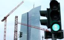 Specialists work on a crane in front of the European Central Bank (ECB) in Frankfurt