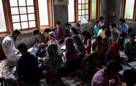 The Wider Image: Barricades and books in restive Kashmir neighbourhood