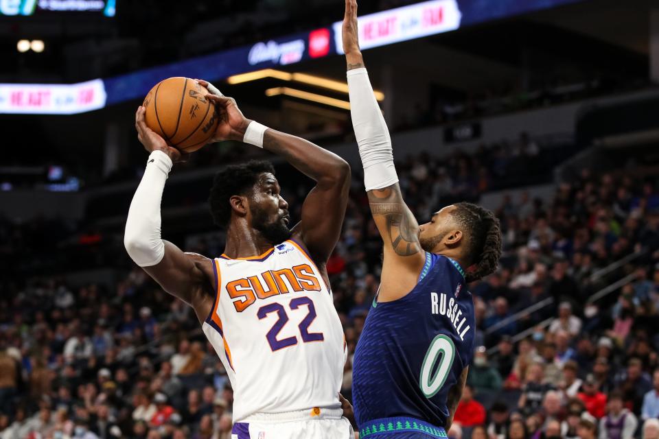 Nov 15, 2021; Minneapolis, Minnesota, USA; Phoenix Suns center Deandre Ayton (22) and Minnesota Timberwolves guard D'Angelo Russell (0) compete in the second half at Target Center.