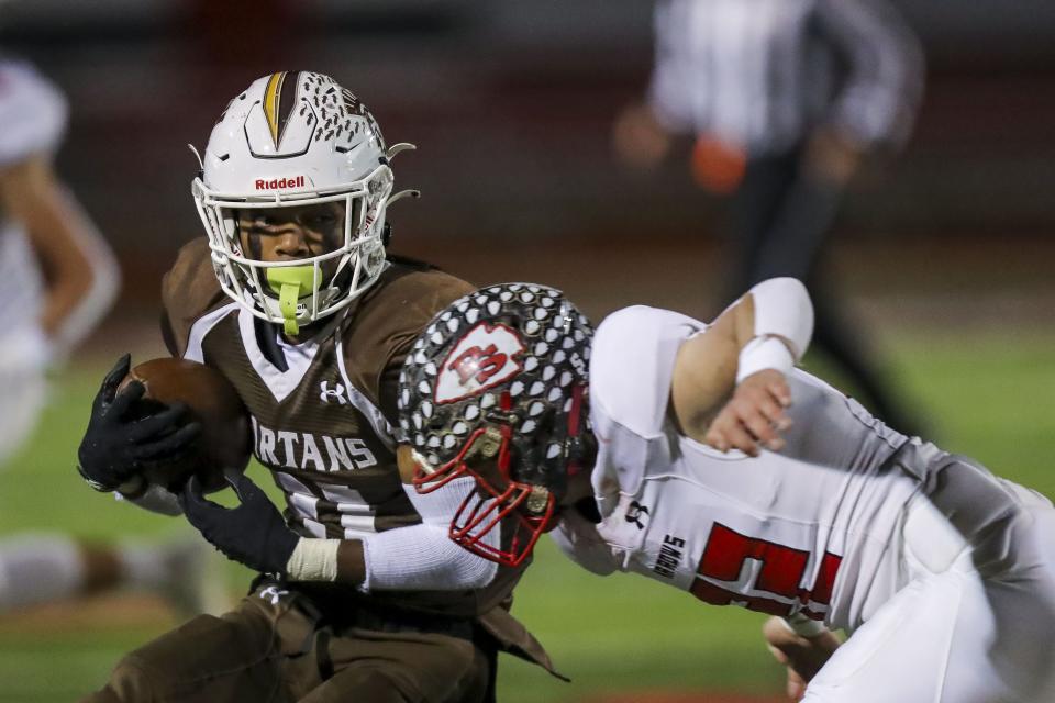 Roger Bacon wide receiver Ty Brenner (11) runs with the ball against Preble Shawnee defensive back Grady Hutchinson (22) in the first half at Lakota West High School, Nov. 13, 2021.