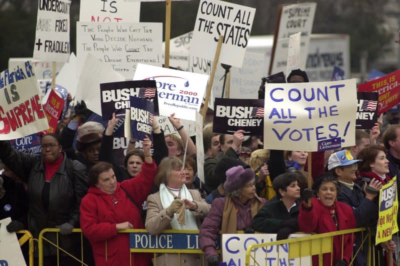 George W. Bush and Al Gore supporters voice their opinions about the Florida recount case outside of the U.S. Supreme Court in Washington, D.C., on December 11, 2000. On December 12, 2000, the Supreme Court ruled against a hand recount in Florida, in effect ensuring Republican Texas Gov. Bush would win the presidency. File Photo by Bill Clark/UPI