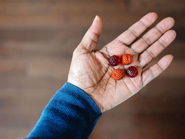 STOCK PHOTO: A woman hold four gummy supplements in the palm of her hand (STOCK PHOTO/Getty Images)