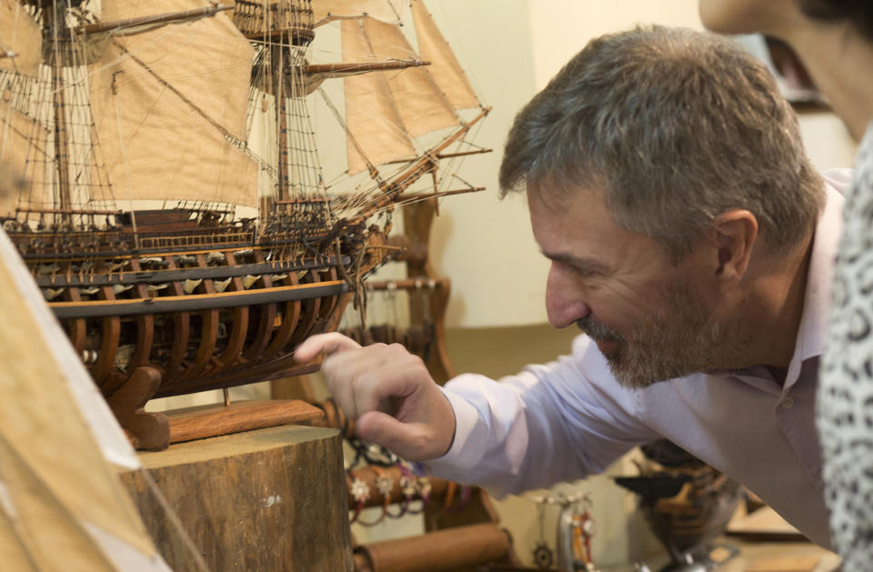 Owner, Grégory Postel inspects a model ship at the Le Village model ship making company in Antananarivo, Madagascar, Wednesday, Sept. 11, 2024. (AP Photo/Alexander Joe)