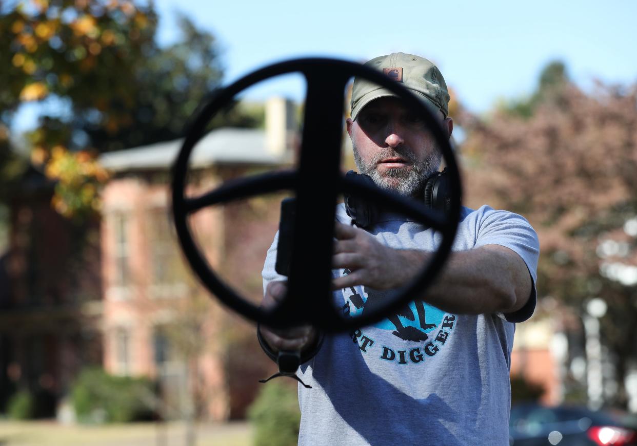 Kentucky Dirt Digger Jared Handley calibrates his metal detector as he prepares for a dig in Henderson, Ky. on Oct. 23, 2023. The business has generated a growing social media following.